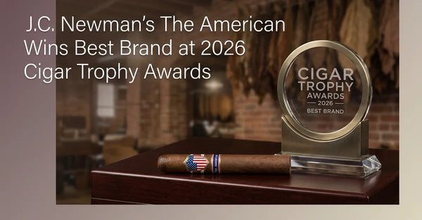 The American cigar by J.C. Newman resting on a wooden surface, representing its win at the 2026 Cigar Trophy awards.