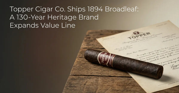A dark Topper 1894 Broadleaf cigar resting on a wooden surface with vintage documents in the background.