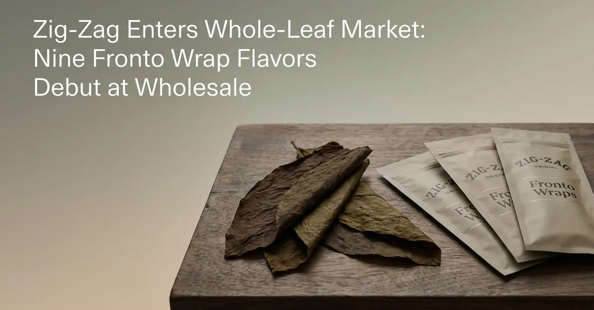 A whole fronto tobacco leaf displayed next to new Zig-Zag Fronto packaging on a wooden surface.